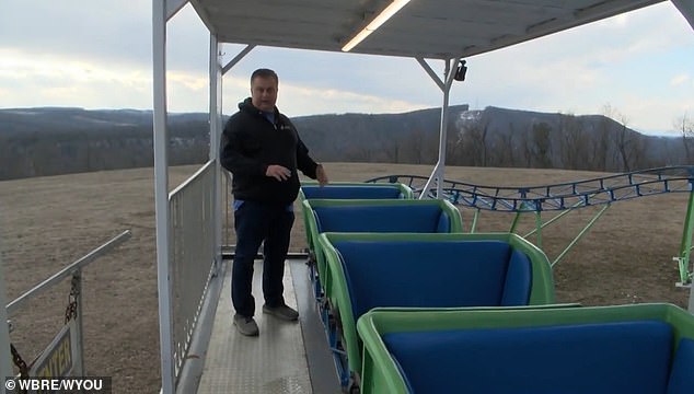 The 60-year-old grandfather has an assortment of attractions in his backyard. But his latest addition, a mini roller coaster (pictured), could endanger the entire 'park'