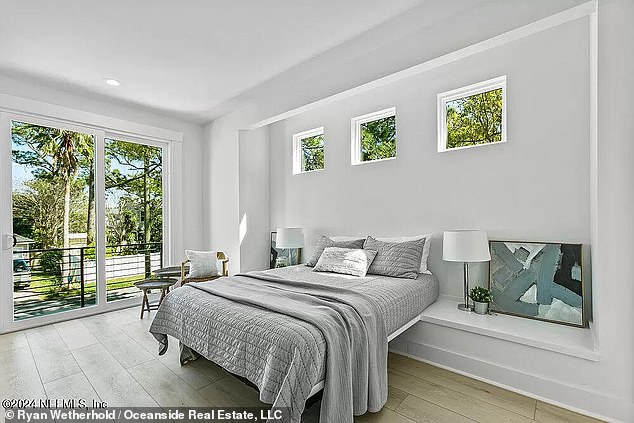 A central staircase opens into a 10-foot vaulted loft space with two full bathrooms, flanked by sun-drenched double bedrooms at either end of the property.