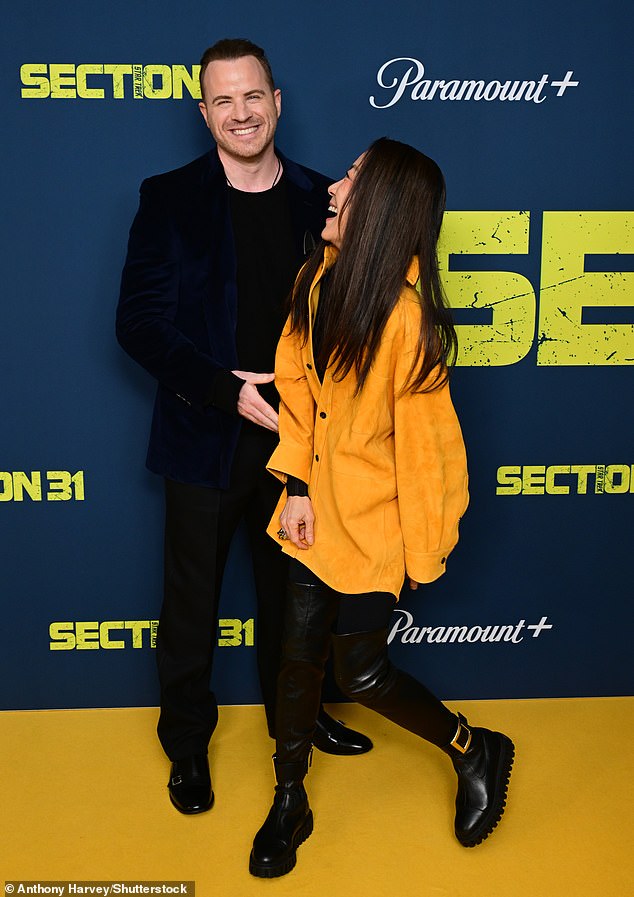 At the premiere, Michelle stood out in a yellow jacket and thigh-high black leather boots