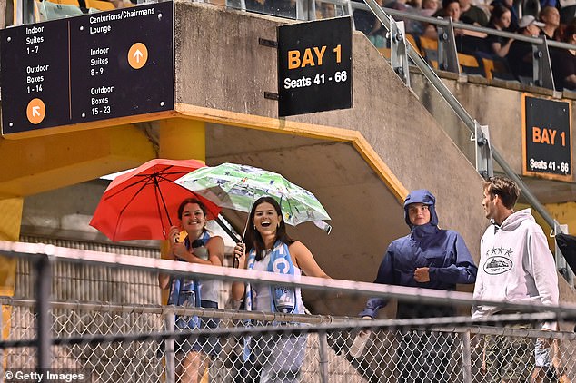 Heavy lightning and thunder forced the A-League Women's match between Sydney FC and Canberra United to be abandoned. The photo shows fans leaving Leichhardt Oval