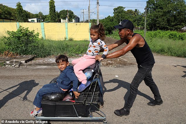 Schools across the country have buckled under pressure to accommodate the influx of migrant students. In the photo: a man and his children in a migrant caravan