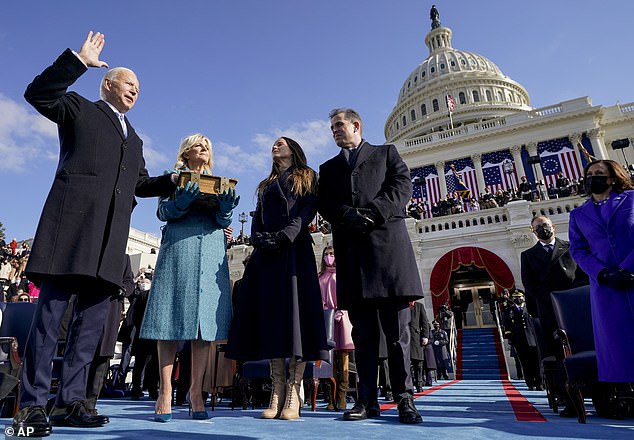 Joe Biden is sworn in as the 46th President of the United States on January 20, 2021 as Jill Biden holds the Bible and their children Ashley and Hunter look on