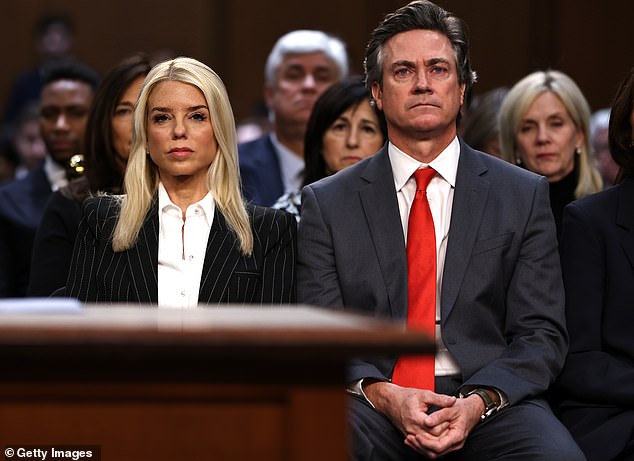 Former Florida Attorney General Pam Bondi (L) prepares to testify before the Senate Judiciary Committee with her fiancé John Wakefield during her confirmation hearing for U.S. Attorney General