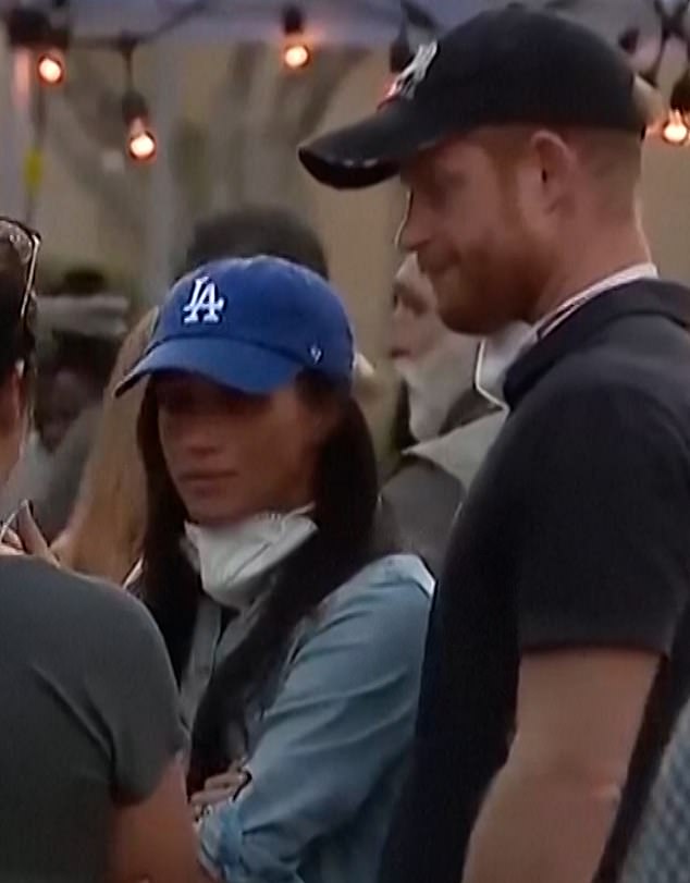 In California, the Duke and Duchess of Sussex have been brutally mocked as 'disaster tourists' after handing out food to victims of the Los Angeles fire. In the photo: Helping fire victims