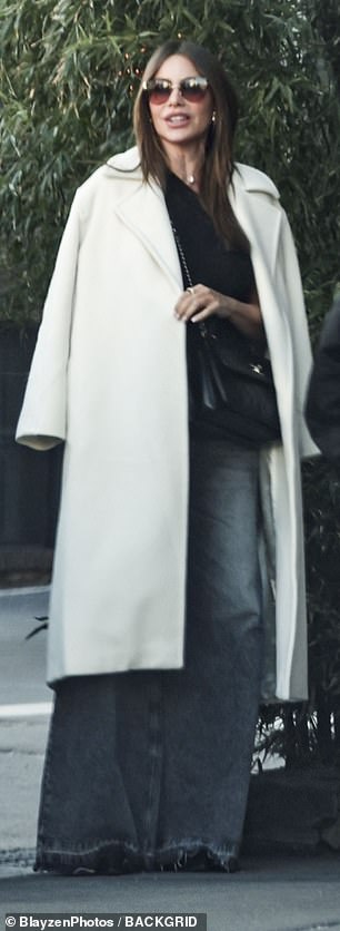 For the lunch outing, she also draped a white wool coat over her shoulders