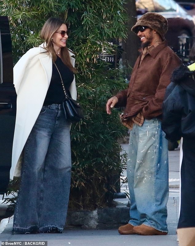 Meanwhile, Lewis kept it low key in baggy, paint-splattered jeans with a brown checked shirt and overcoat