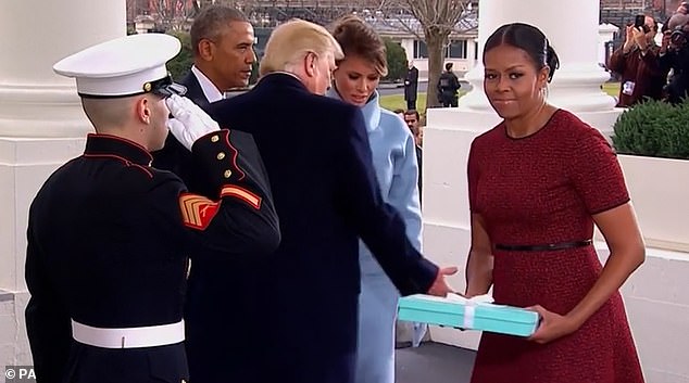 The couples shared a chilling exchange during the Trumps' move into the White House eight years ago. Melania presented Michelle with a gift - a picture frame, beautifully packaged in a blue Tiffany box - but the outgoing First Lady awkwardly fumbled with the package before handing it to Barack, who passed it to a nearby aide.