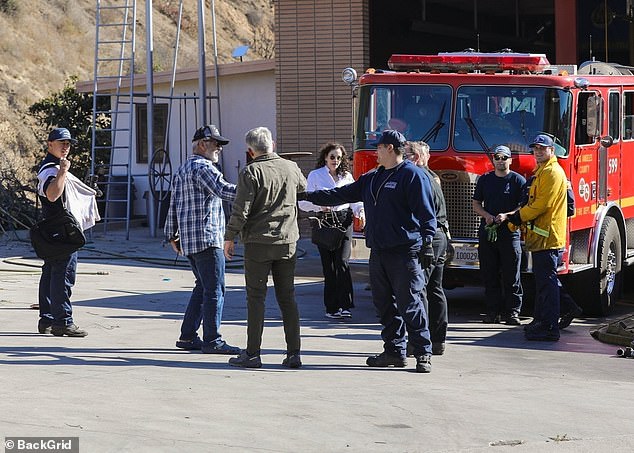 Gibson was seen shaking hands with firefighters and first responders, apparently thanking them for their efforts in battling the devastating infernos that have killed at least 25 people and destroyed more than 12,000 buildings.