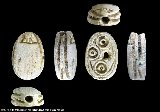 Archaeologists also found a wealth of artifacts from the 8th century BC, sealed behind a stone wall in a cave. These include cooking pots, jars containing fragments of ancient Hebrew inscriptions, loom weights, scarabs, stamped seals with decorative motifs, and millstones used for grinding grains.