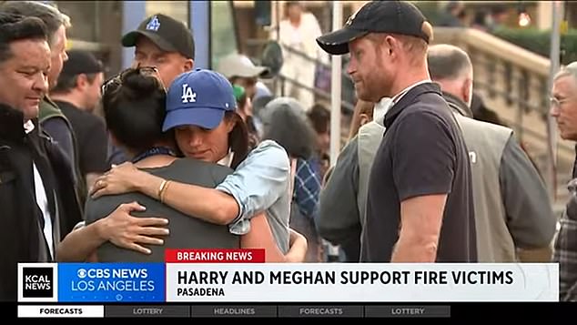 Meghan hugs a victim of last week's California wildfires as Harry looks on