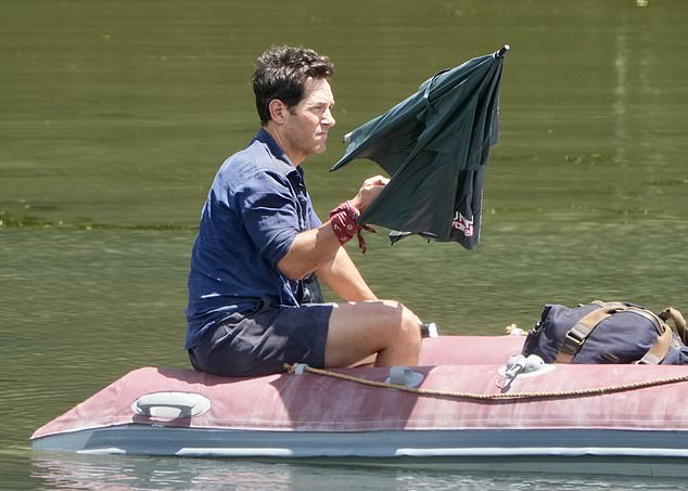 The ageless hunk dressed in his movie outfit, consisting of a blue short-sleeved work shirt and matching shorts