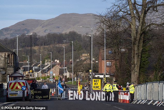 However, his visit did attract some protesters, who were seen at the end of the road holding 