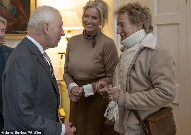 The veteran rocker (pictured, right) seemed happy to exchange words with the monarch (left), while his wife Penny Lancaster (middle) also joined the conversation