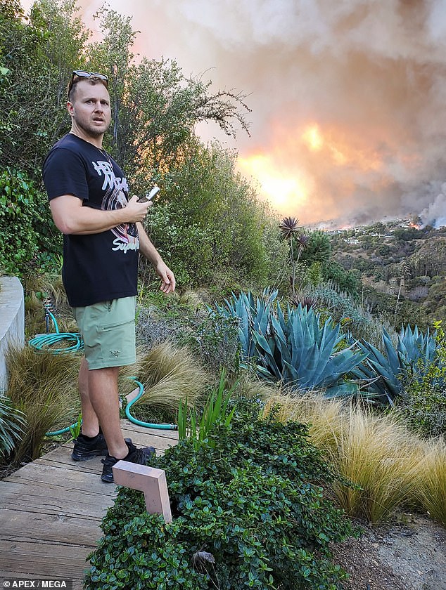 Spencer Pratt, 41, was captured in photos watching the fast-moving fire move toward his home, which is in an area with many celebrity estates also at risk of burning.