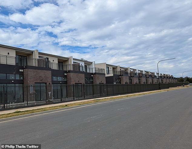 Photos of the completed project, however, tell a different story: the new suburb looks more like a prison, an austere row of townhouses with a row of dead grass on the verge.