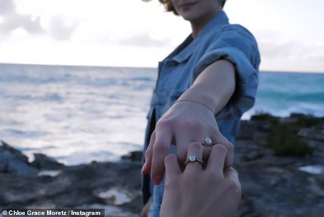 The Kick Ass actress, 27, shared a new photo of herself and the Playboy model, sporting matching rings on their left hands