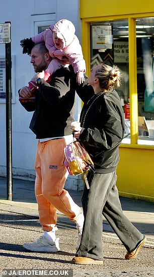 Chloe wore a loose black jacket and pants, teamed with a pair of brown UGG boots