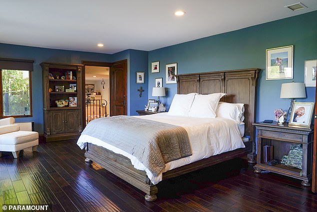 The couple's master bedroom features real oak floors and timeless antique furniture