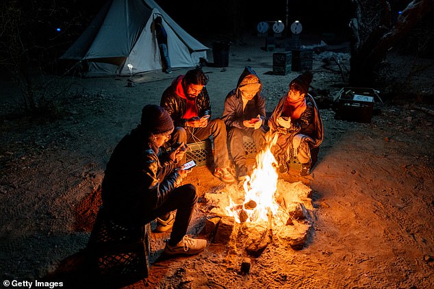 Trump promised the largest deportation in history when he took office on January 20. Migrants from Ecuador and India sit together near a fire awaiting their arrest by U.S. Customs and Border Patrol agents after crossing part of the border wall into the U.S. in January. August 5, 2025 in Ruby, Arizona