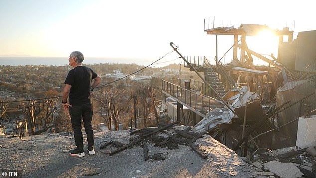 A Pacific Palisades resident surveys the damage to his neighborhood after it was destroyed by fires this past week