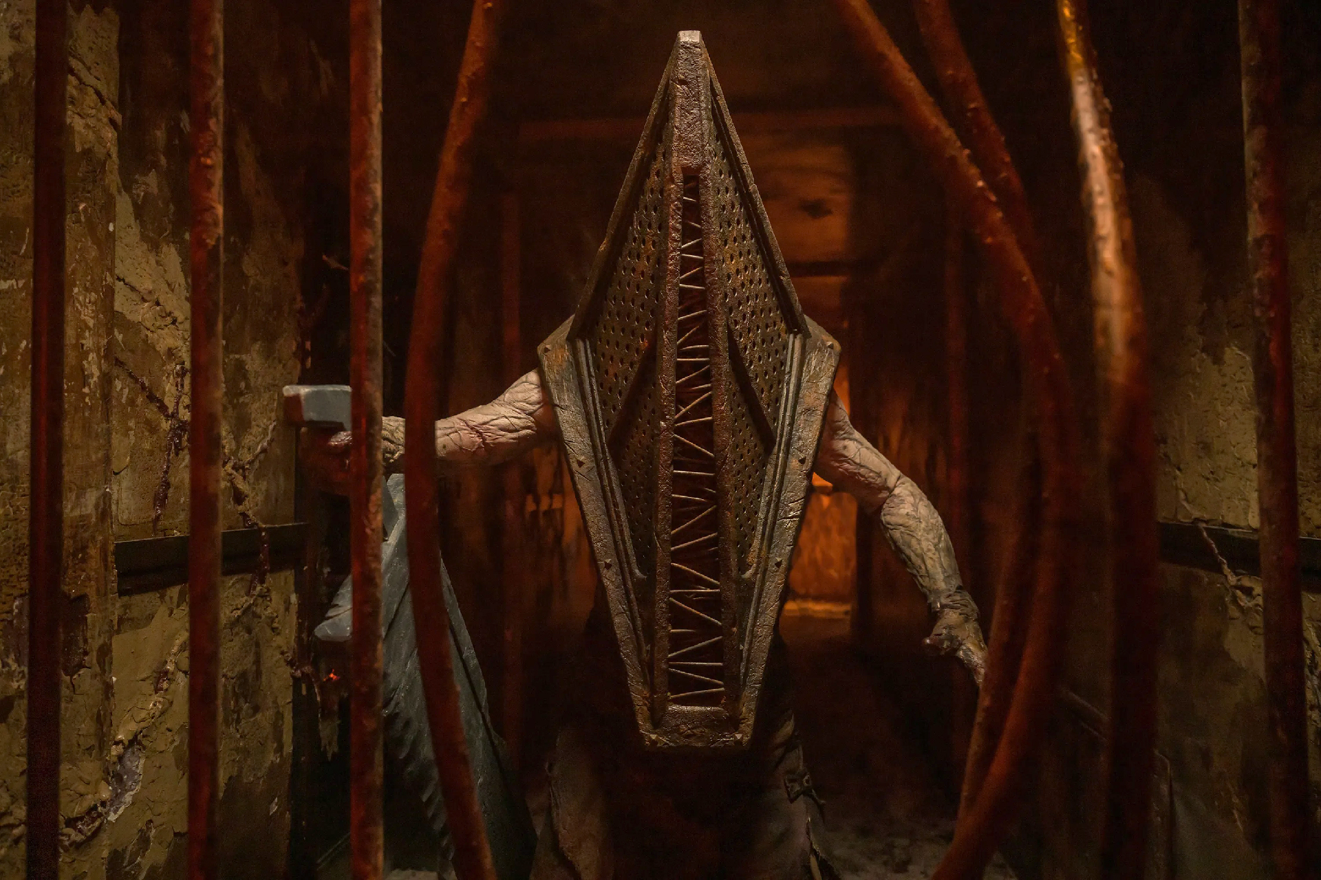 A shot of Pyramid Head's upper body with his giant plate knife in his right hand from the film Return to Silent Hill