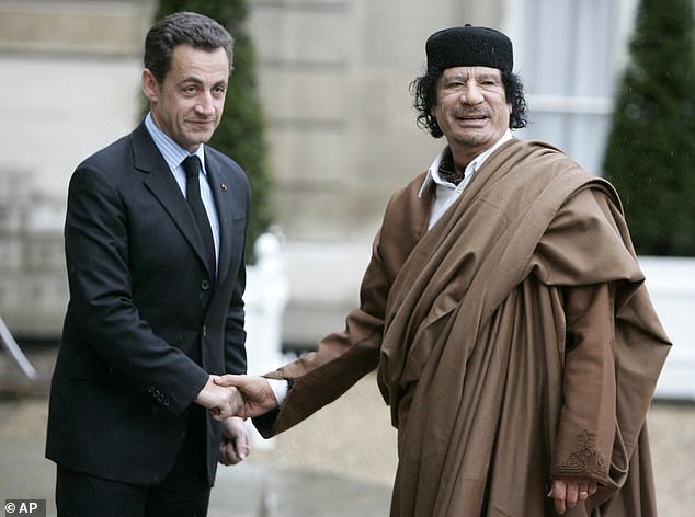 French President Nicolas Sarkozy, left, greets Libyan leader Colonel Moammar Gadhafi upon his arrival at the Elysée Palace in Paris, December 10, 2007