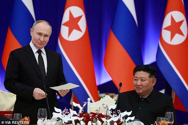 Russian President Vladimir Putin and North Korean leader Kim Jong Un attend a state reception in Pyongyang, North Korea, June 19, 2024