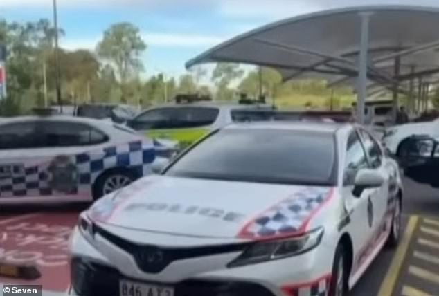 Several police vehicles remained at the shopping center while forensic officers at Coles took photographs and searched the crime scene.