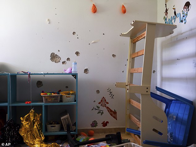 Bullet holes cover the bedroom wall of hostage Ariel Bibas, 4, in his home in Kibbutz Nir Oz, Israel