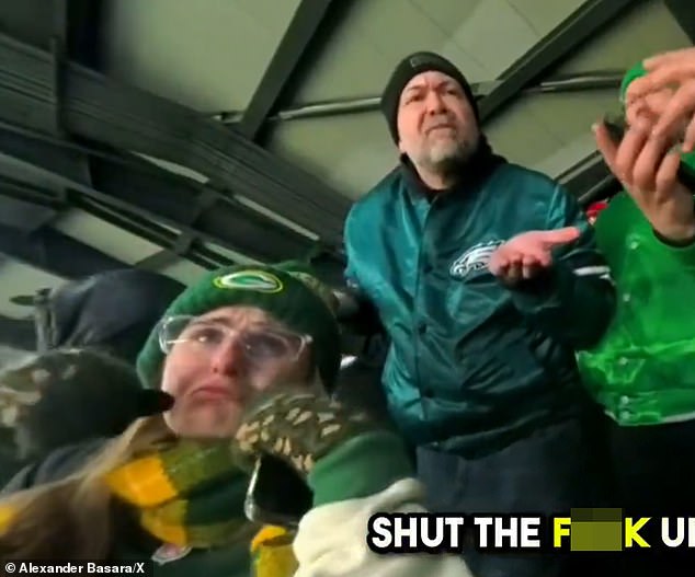 Caldwell is seen shouting at the woman – who is wearing a Packers hat – from his seat in the row behind him