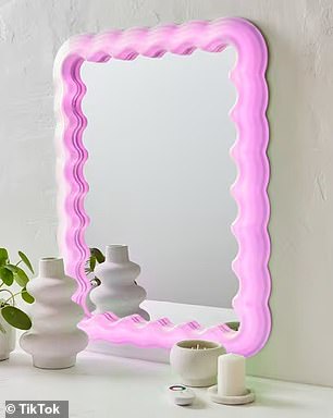 Home style enthusiasts are rushing to get their hands on Kmart's very trendy Light Up Wavy Mirror, which costs just $69