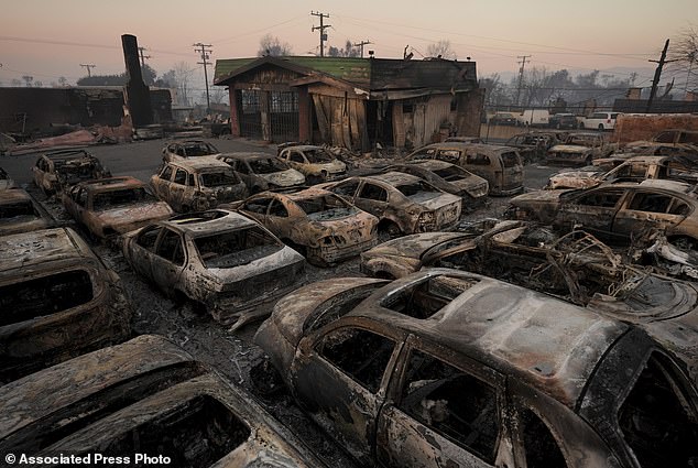 Cars are left charred at a dealership Friday in the aftermath of the Eaton fire