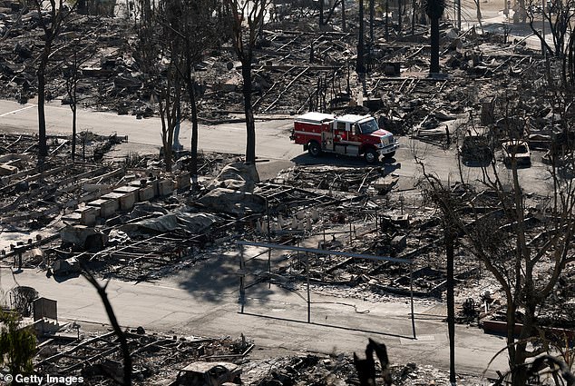 A fire crew drives through a mobile home park that was destroyed by the Palisades Fire