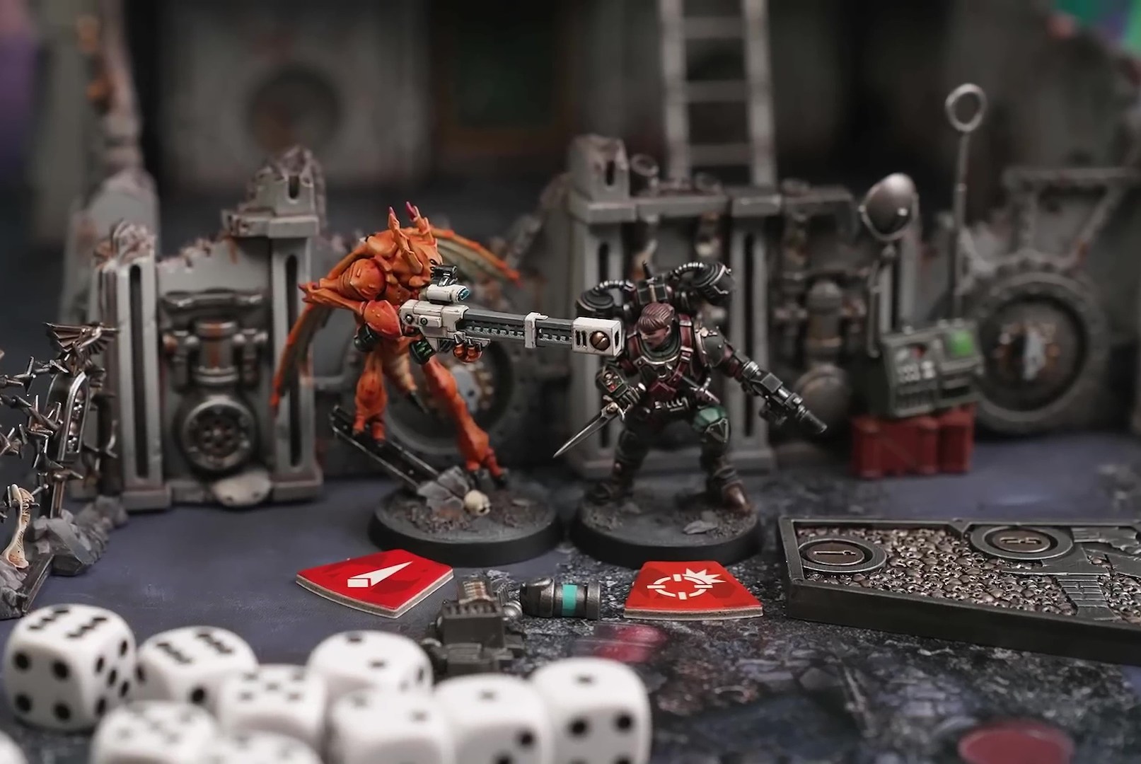 Two miniatures from Warhammer 40,000: Kill Team - Hivestorm facing each other. One is a heavily armored member of the Imperial Guard; the other is one of the Vespid Stingwings of the Tau. There are dice and game chips in the foreground of the image