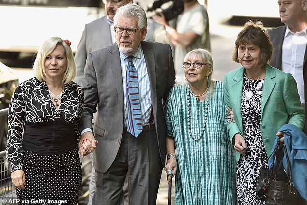 Rolf Harris arrives with his wife Alwen Hughes (second from right) and daughter Bindi (left) at Southwark Crown Court in central London on June 30, 2014