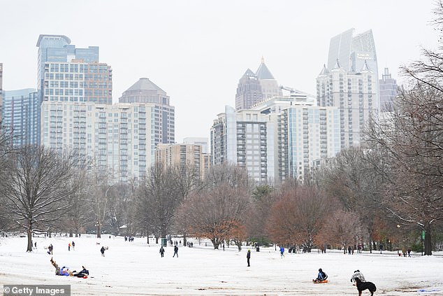 Atlanta residents head to Piedmont Park on Friday to walk around and sled