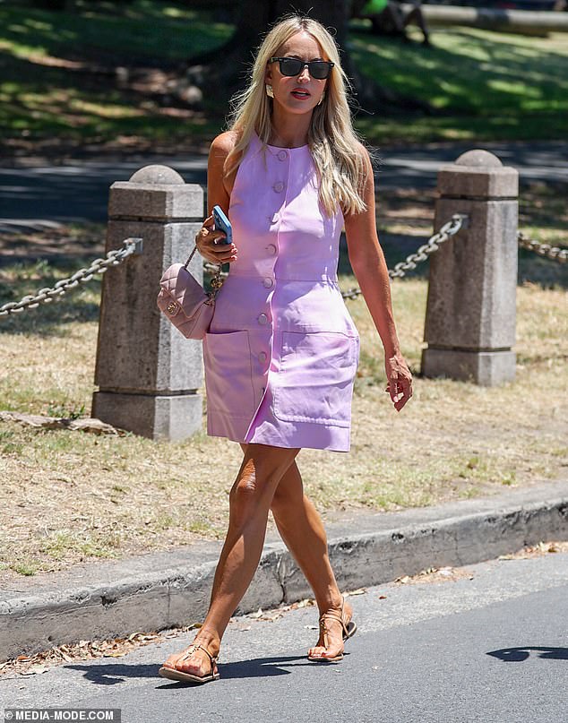 Jackie kept the pink memo by accessorizing with an $8,000 pale pink Chanel mini flap bag, as well as a pair of nude sandals and chunky gold earrings