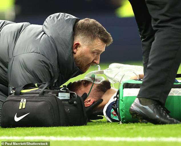 Medics treated him for nine minutes, after which he was carried away to applause from both groups of supporters