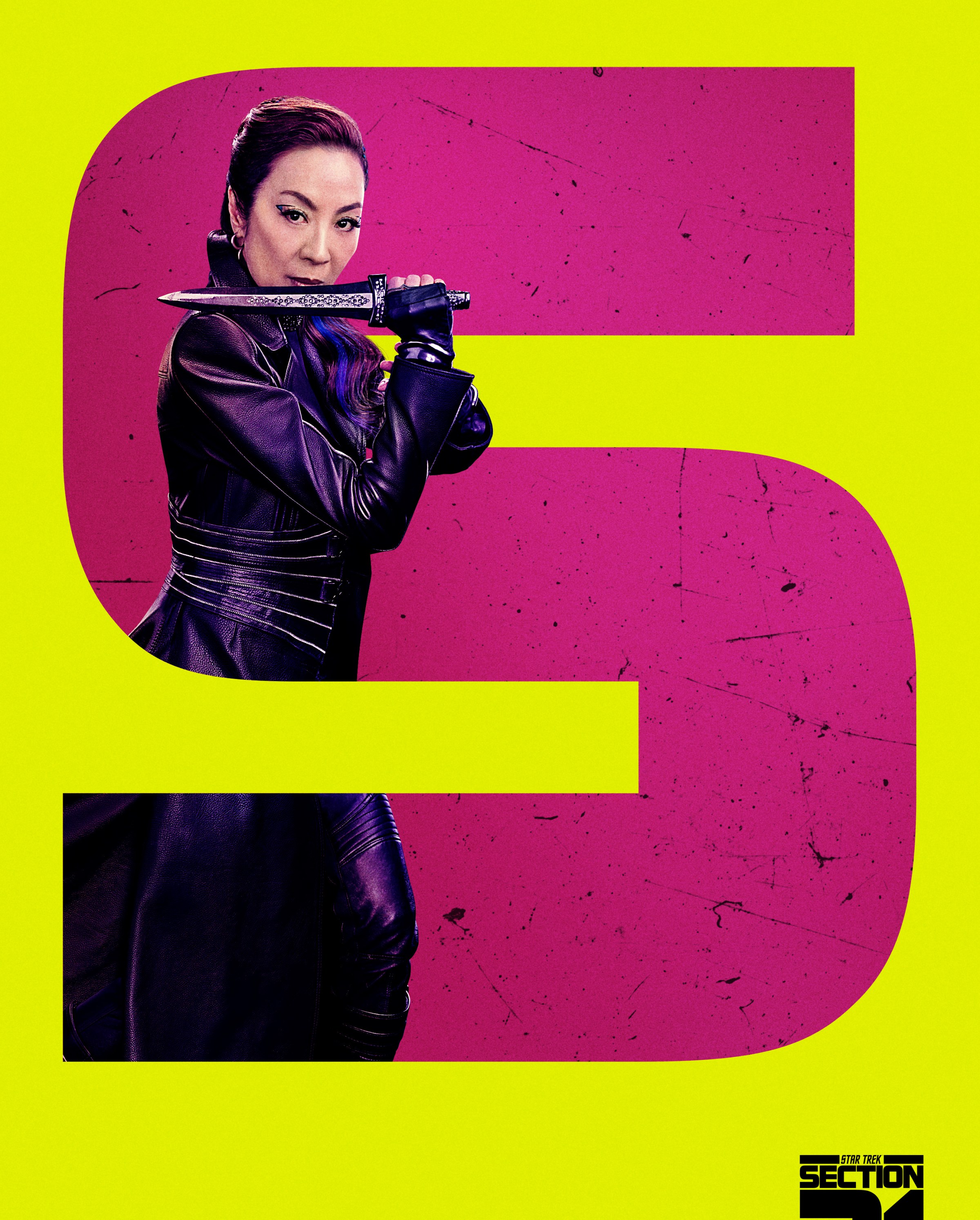 Michele Yeoh poses as Philippa Georgiou in a leather duster with a dagger in a large 'S' image for 'Section 31' on a poster for the film of the same name.