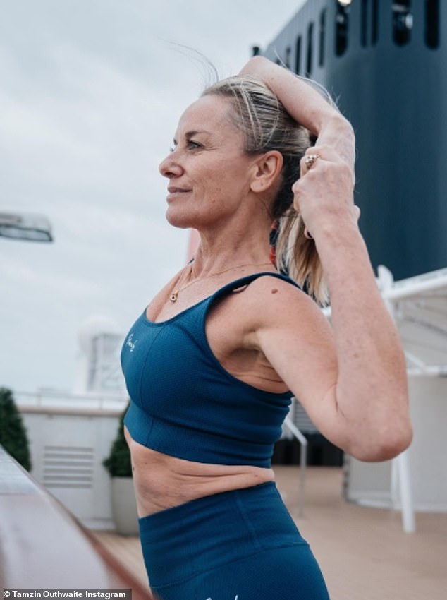 She shared photos of herself in a blue sports bra and matching leggings as she showed off her impressive flexibility as she stretched out on the deck