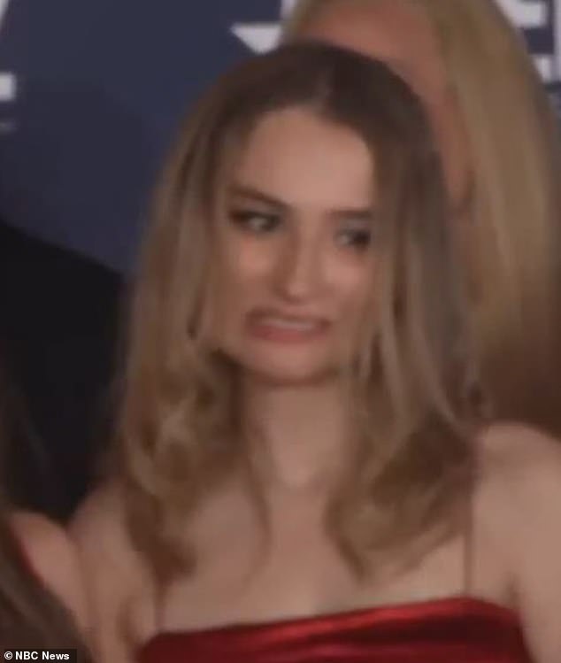 Caroline, who was seen wearing a red dress, scrunched up her face