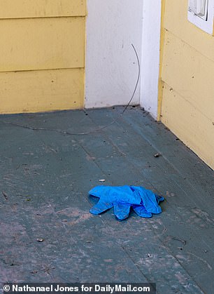 A pair of blue latex gloves were found discarded on the porch