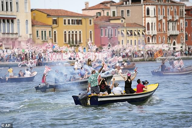 'No Big Ships' activists stage a protest as the MSC Orchestra cruise ship leaves Venice, Italy, Saturday, June 5, 2021