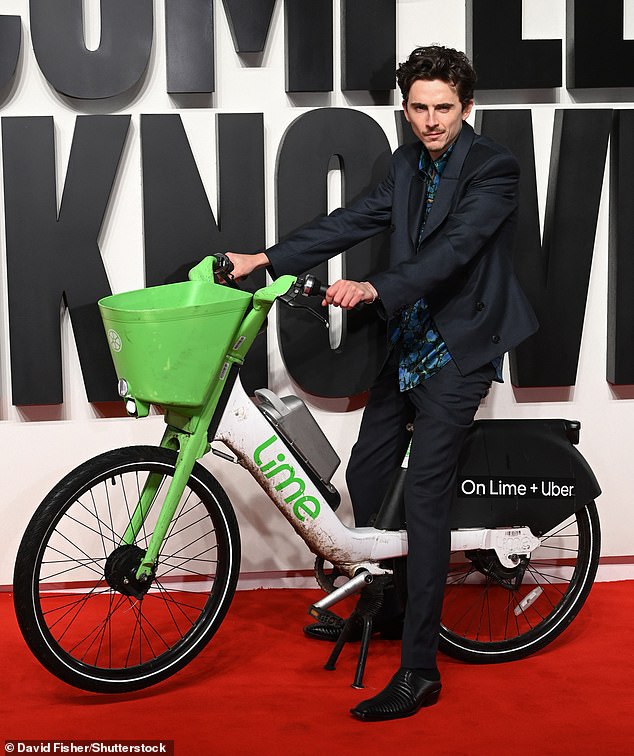 Timothée Chalamet stood out from the crowd as he rode onto the red carpet on one of London's famous Lime Bikes