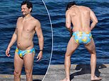 Australian Idol star Rob Mills turns heads on a Sydney beach as he takes a dip in a pair of sleek duck-themed Budgy Smugglers