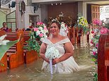 Beautiful day for a wet wedding! Bride walks down the aisle in waist-deep water after church floods