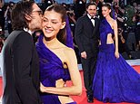 Nicola Peltz receives a kiss from husband Brooklyn Beckham and dazzles in a cut-out cobalt blue dress on the red carpet in Venice after receiving her Rising Star award