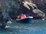 Moment when dozens of migrants wade ashore on the busy Spanish island beach after arriving by 'taxi boat'
