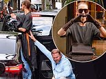 Celine Dion gets a helping hand from a member of her team as she greets fans in stunning high heels